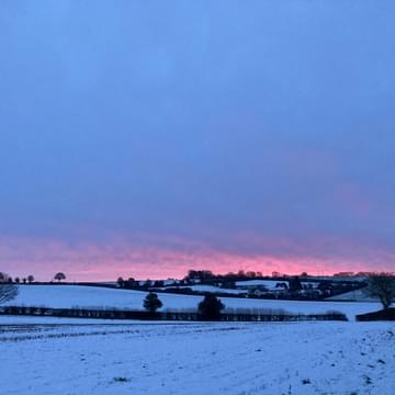 A view of snow covered fields at dusk